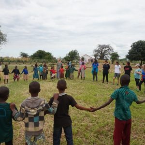 children holding hands in a circle
