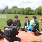 Boys having a chat outside on a field