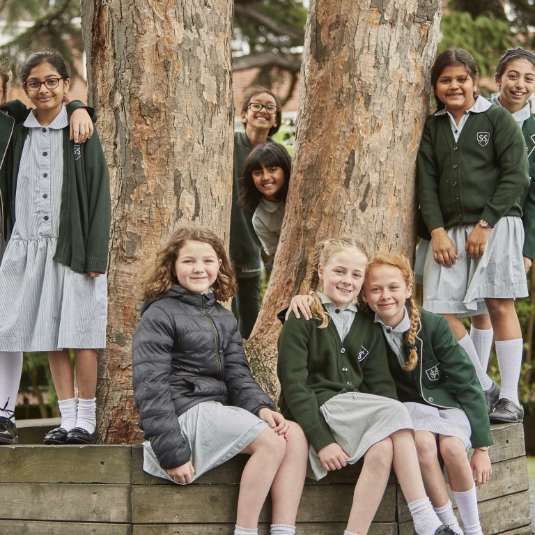 students sat by a tree