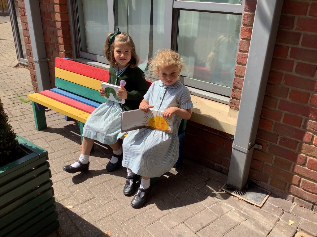 2 girls reading The Hungry Caterpillar