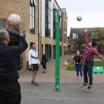 staff members throwing balls into a hoop