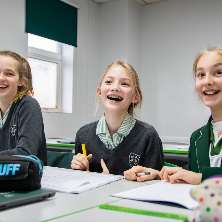 students smiling in class