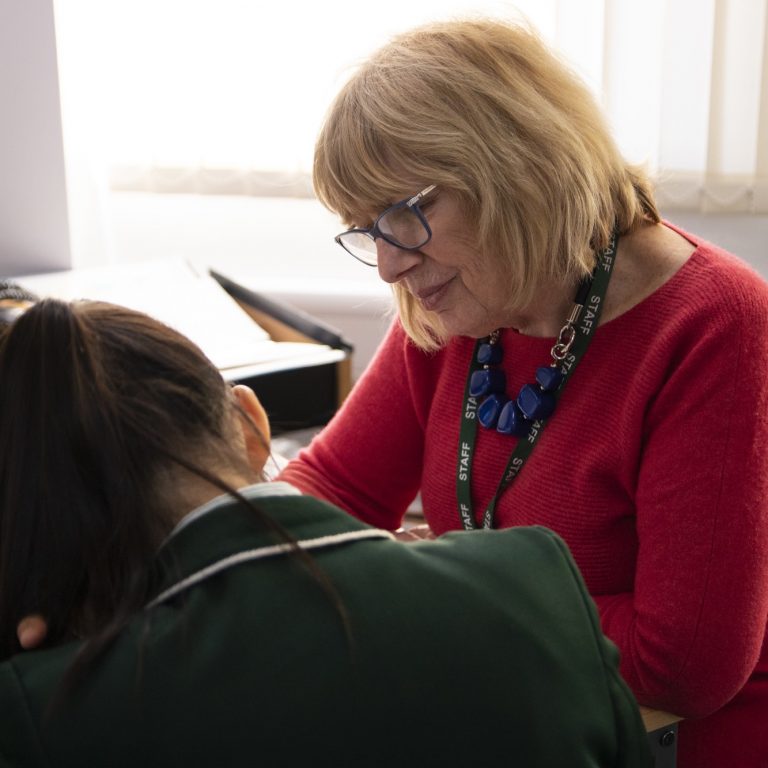 student working with her teacher