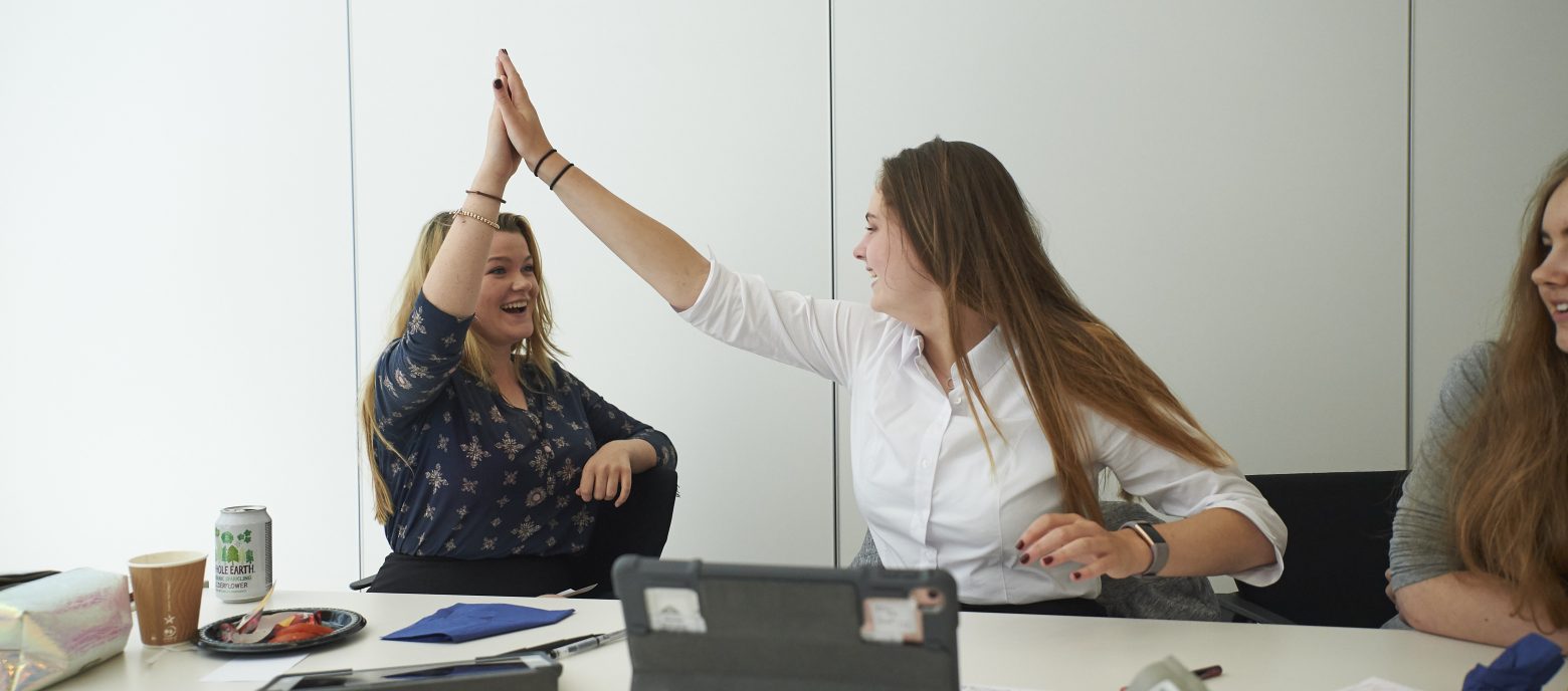 Students high fiving each other