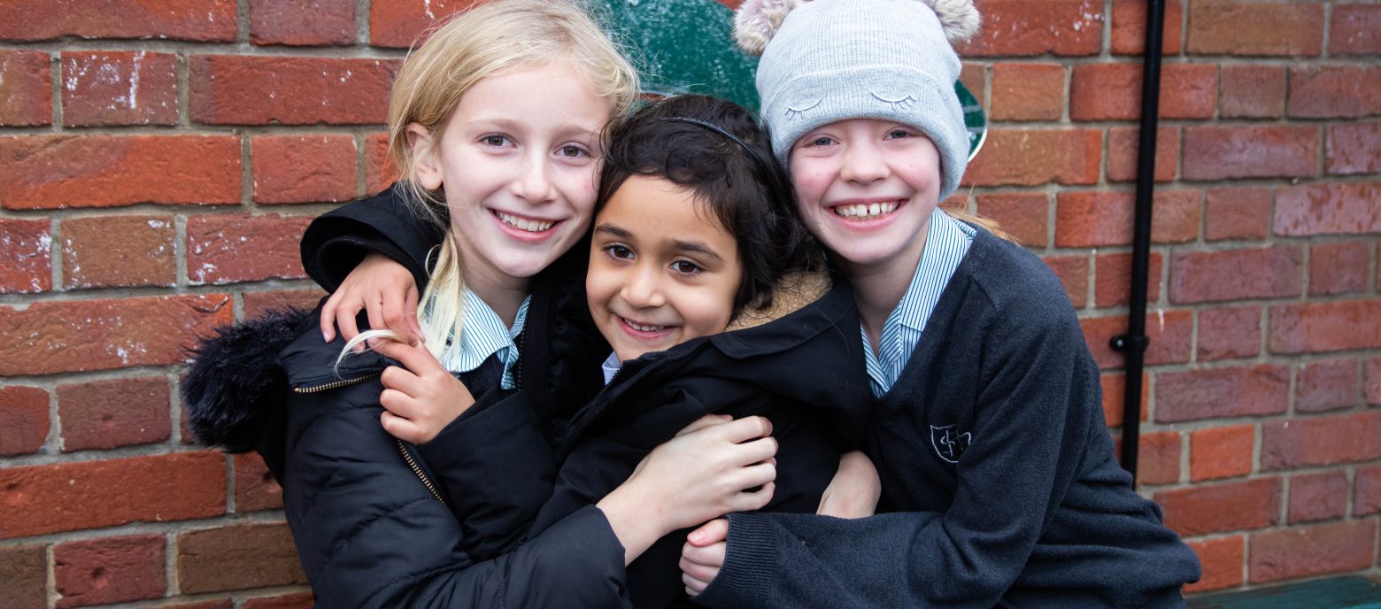 3 students hugging