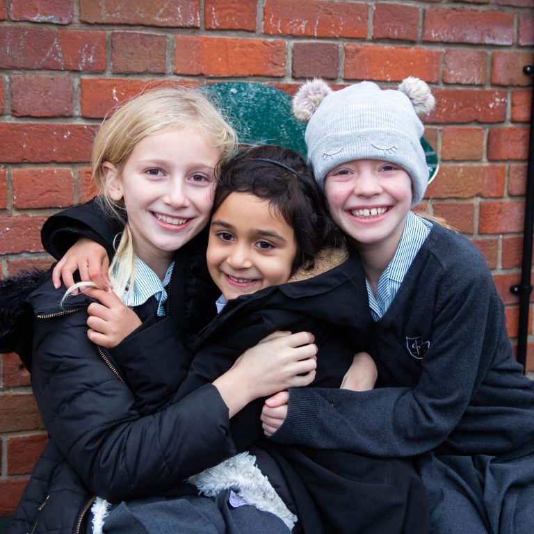 3 students hugging