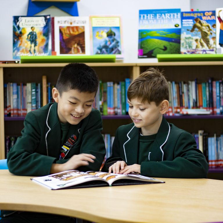 2 boys reading a book