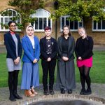 5 students stood around the front of the school