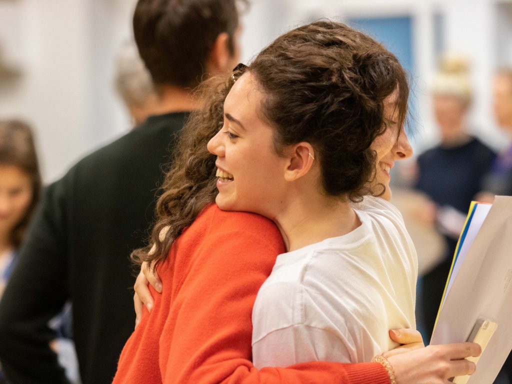 student and parent having a hug