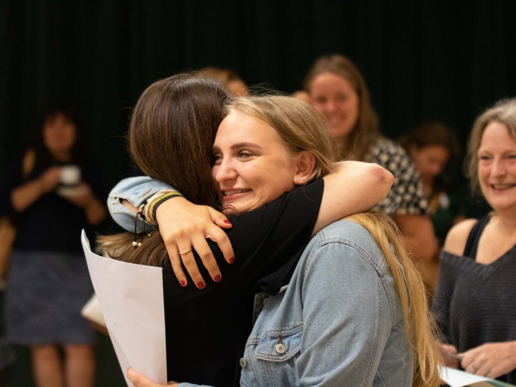 students hugging