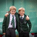2 students with their arms around each other