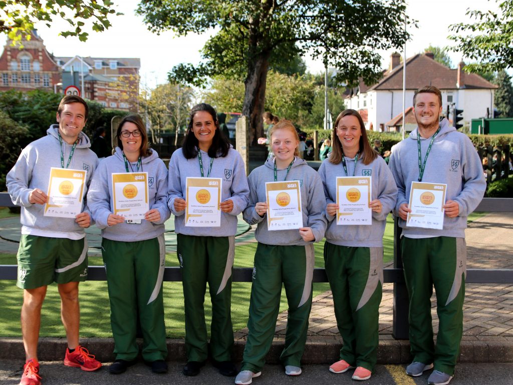 staff holding certificates