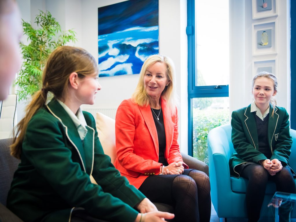 a teacher talking to two students