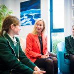 a teacher talking to two students