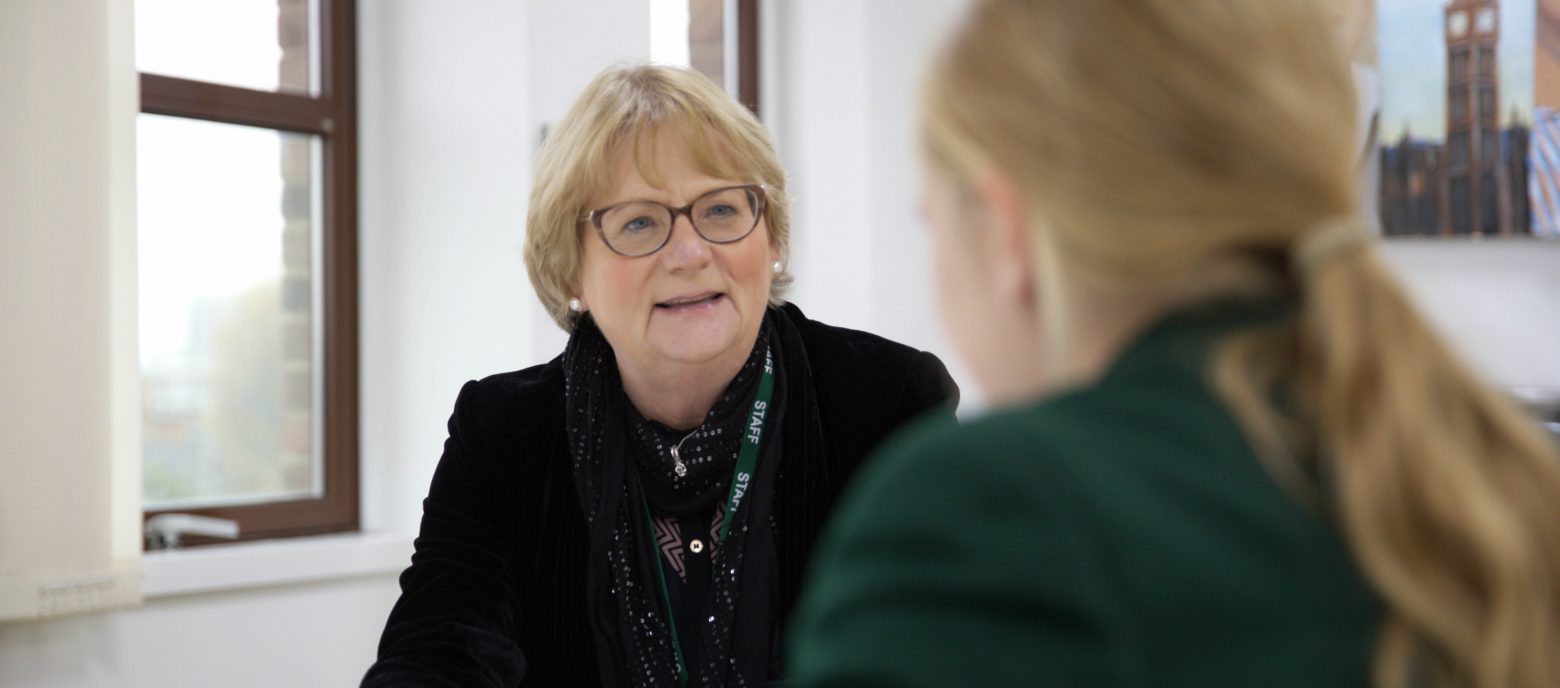 teacher talking to a student