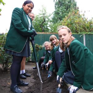 students gardening outside