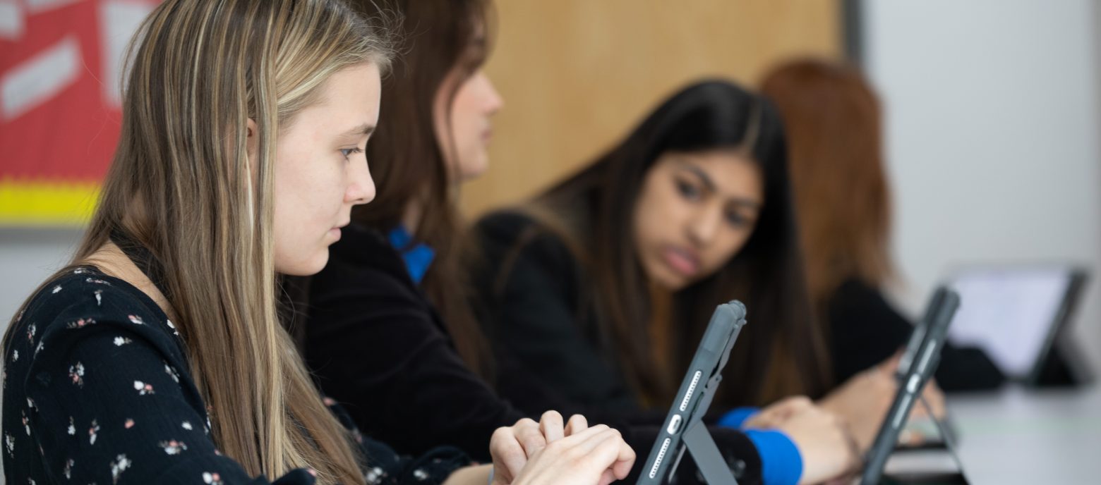 students using iPads to work