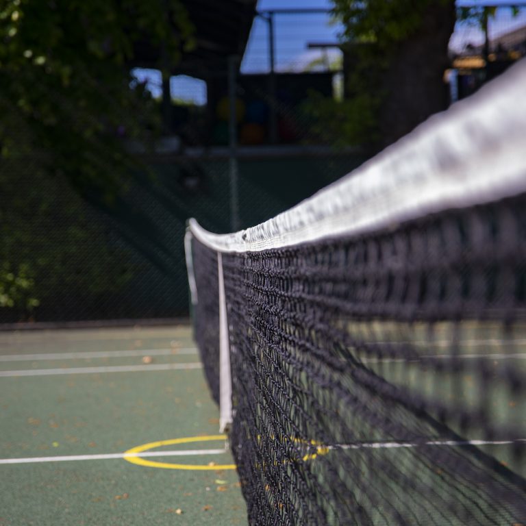 the middle of a tennis court with the tennis net