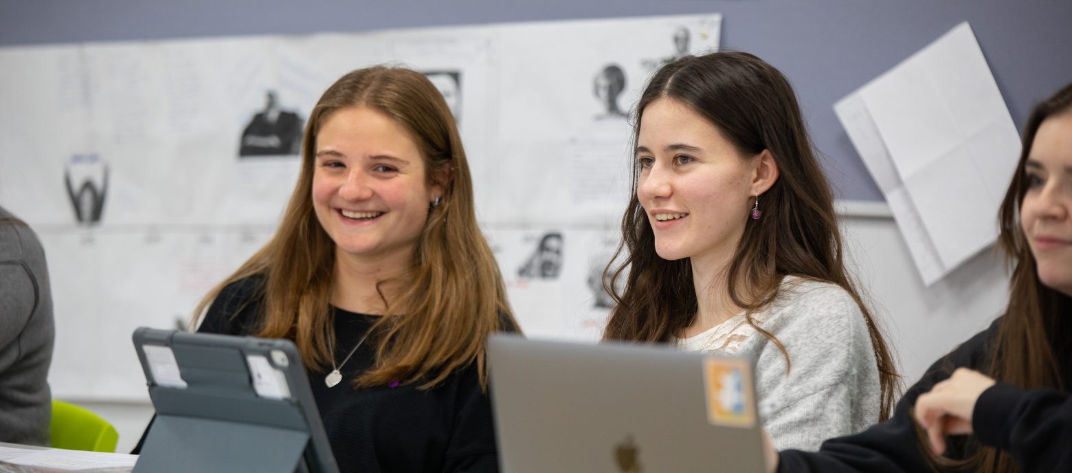 Students in the class using iPads and laptops