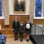 girls stood with a certificate