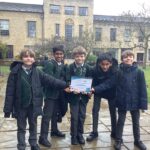 students holding up a certificate