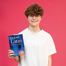 student holding a latin book