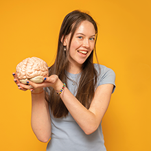 student holding a brain