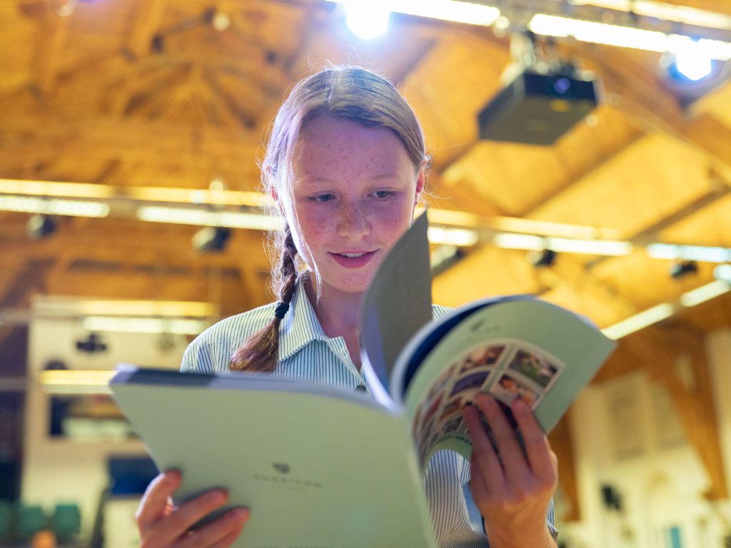 Girl flicking through a booklet