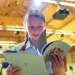 Girl flicking through a booklet