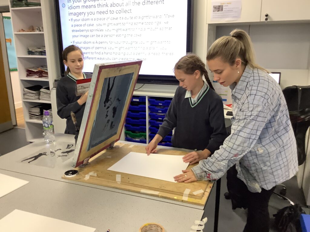 Women with two school girls screen printing