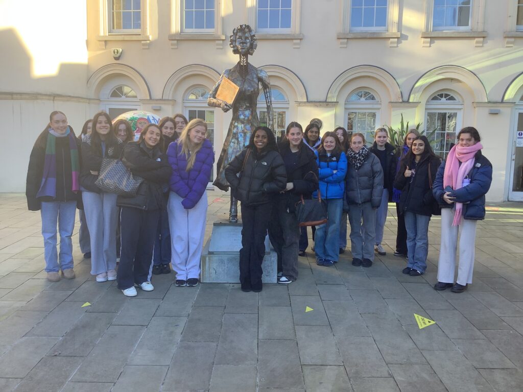 Group of female students standing in front of building