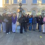 Group of female students standing in front of building