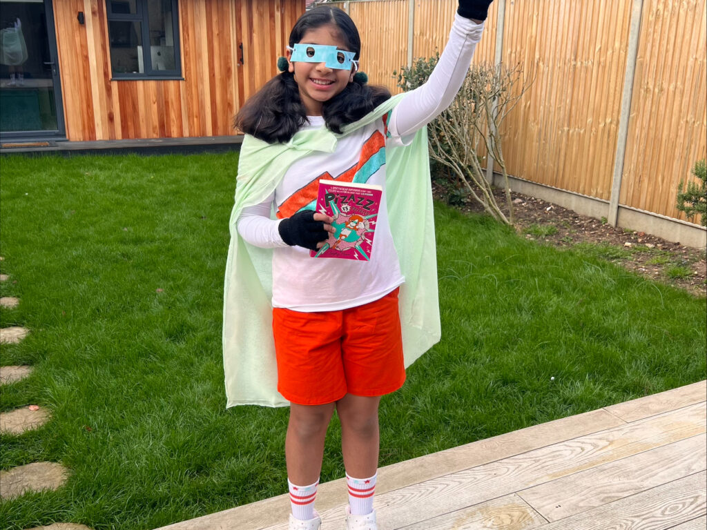 Girl standing in garden dressed up for World Book Day