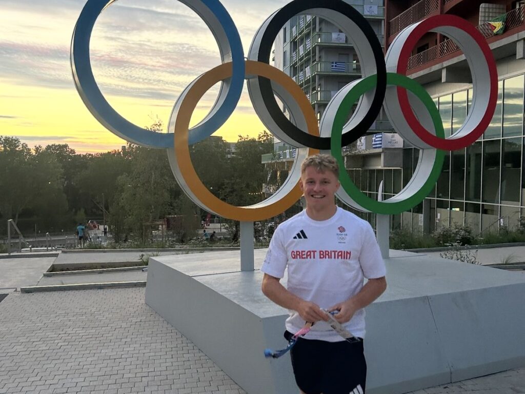 Man stands in GB shirt in front of Olympic Rings, Paris
