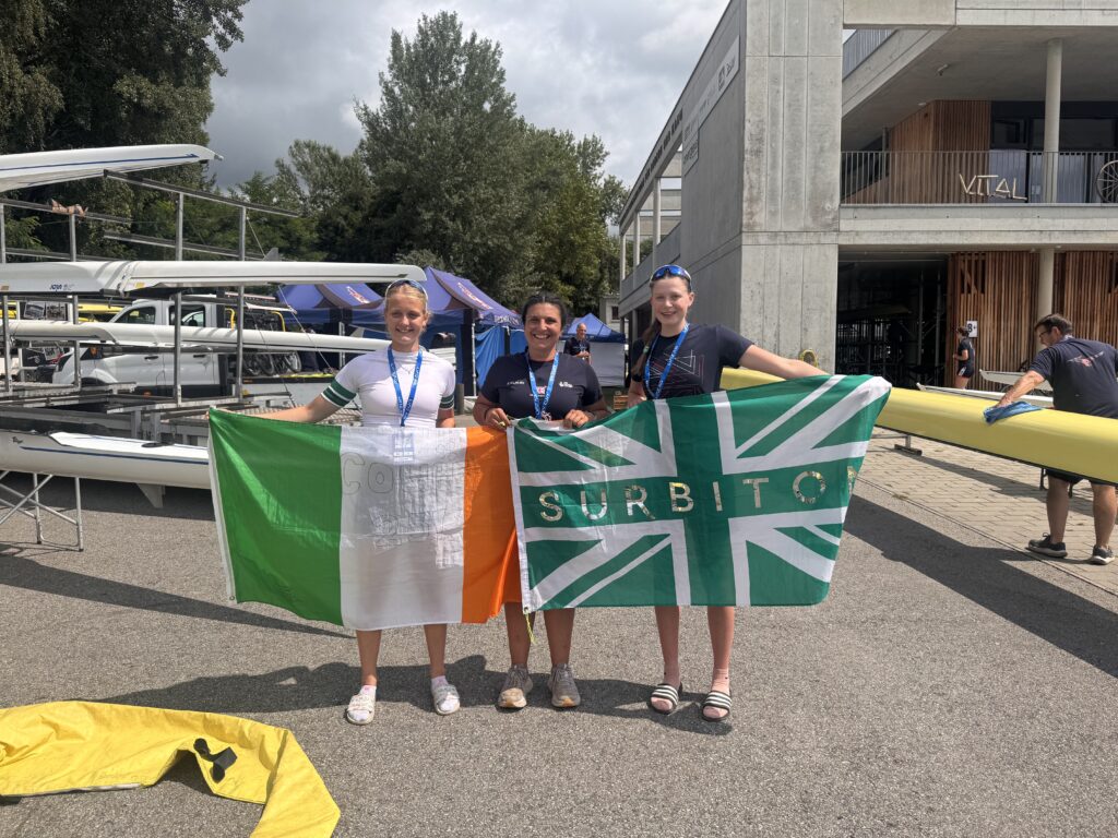 Three women holding ireland and GB flag