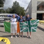Three women holding ireland and GB flag